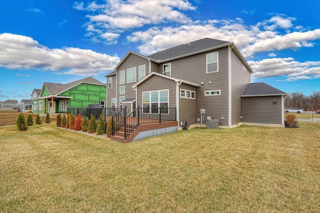 back of property with a lawn, cooling unit, and a deck