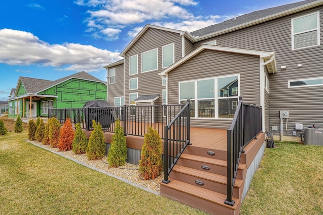 back of property with central air condition unit, a lawn, a wooden deck, and a residential view