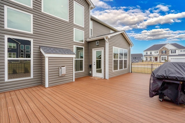 wooden terrace with grilling area and a residential view