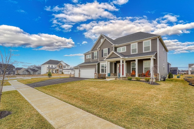 view of front of property with aphalt driveway, a porch, a residential view, a front yard, and an attached garage