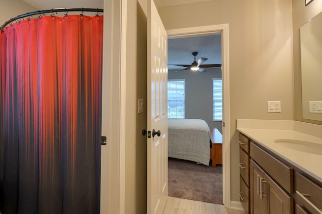 ensuite bathroom with vanity, ensuite bathroom, and a ceiling fan