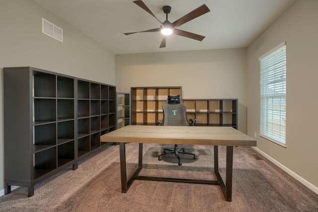 carpeted home office with visible vents, baseboards, and a ceiling fan