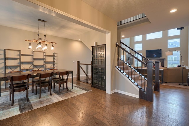 dining area with hardwood / wood-style floors, baseboards, an inviting chandelier, recessed lighting, and a textured ceiling