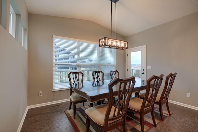 dining area featuring visible vents, lofted ceiling, baseboards, and dark wood finished floors