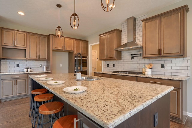 5511 Timber Heights Ln, Grove City, OH 43123 - kitchen with wall chimney range hood, a sink, a kitchen island with sink, stainless steel appliances, and dark wood-type flooring