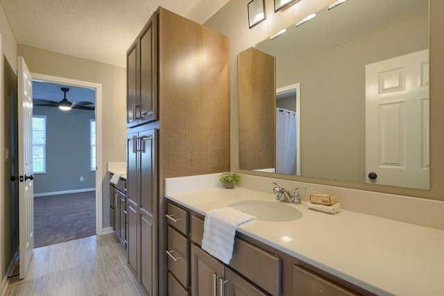5511 Timber Heights Ln, Grove City, OH 43123 - bathroom with vanity, a ceiling fan, baseboards, and a textured ceiling