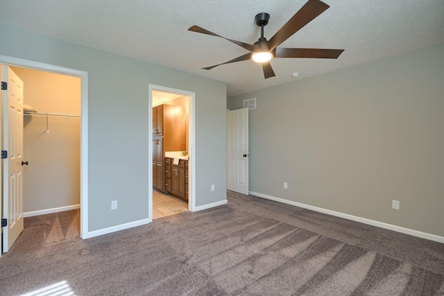 5511 Timber Heights Ln, Grove City, OH 43123 - unfurnished bedroom featuring visible vents, baseboards, a walk in closet, and light colored carpet