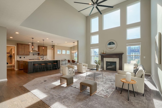 5511 Timber Heights Ln, Grove City, OH 43123 - living room featuring dark wood-type flooring, a ceiling fan, a wealth of natural light, and a tile fireplace