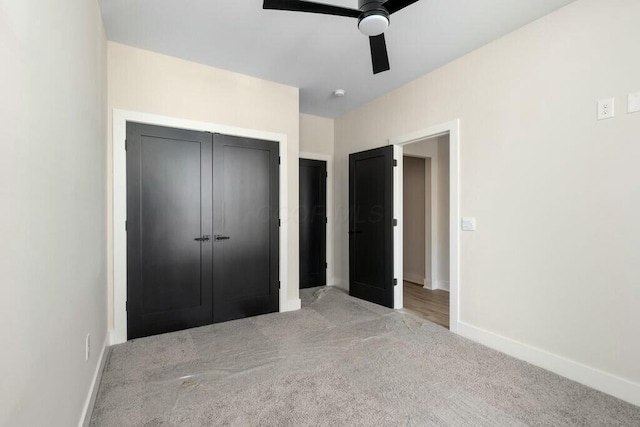 unfurnished bedroom with light carpet, ceiling fan, baseboards, and a closet