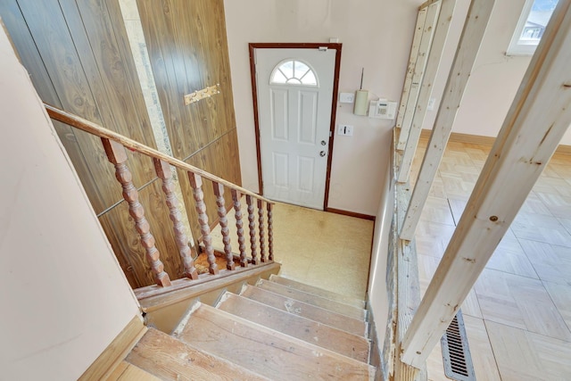 entrance foyer featuring stairway and baseboards