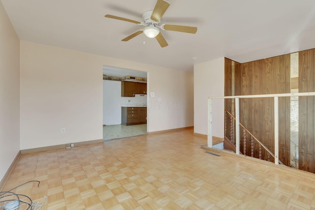 unfurnished room featuring baseboards and ceiling fan