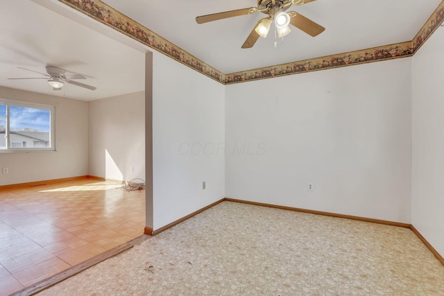 carpeted empty room with baseboards and ceiling fan