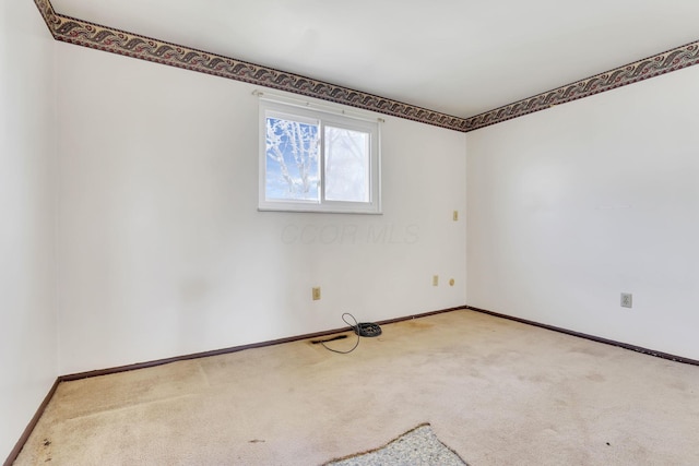 carpeted spare room with baseboards