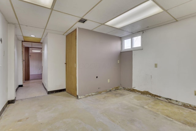 below grade area featuring a drop ceiling and baseboards