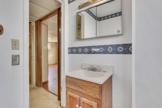 bathroom featuring vanity, tile patterned floors, and a drop ceiling