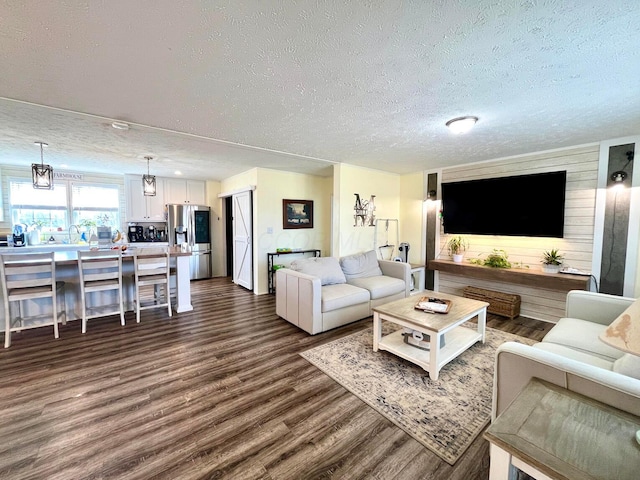 living room featuring dark wood-style floors and a textured ceiling