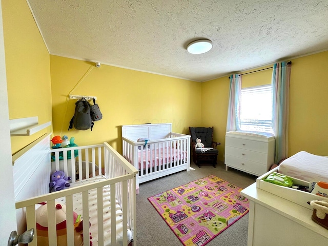 bedroom with carpet flooring and a textured ceiling