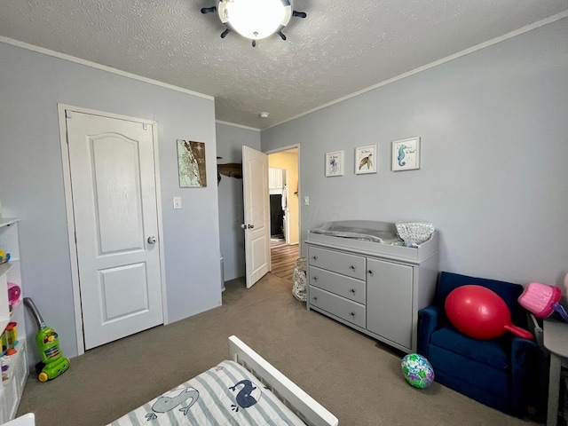 bedroom featuring a textured ceiling, ornamental molding, and carpet