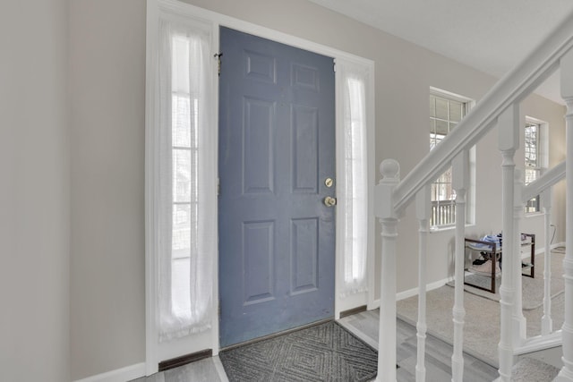 entryway with baseboards and stairs