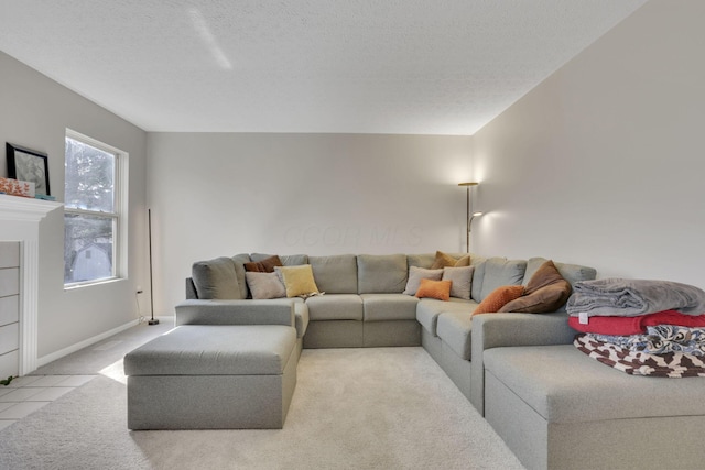 carpeted living room with baseboards and a textured ceiling