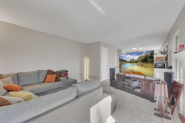 living area featuring visible vents, carpet floors, and ceiling fan