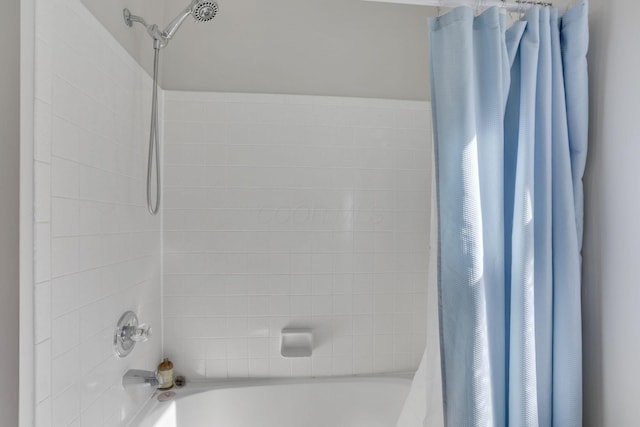 bathroom featuring shower / bathtub combination with curtain