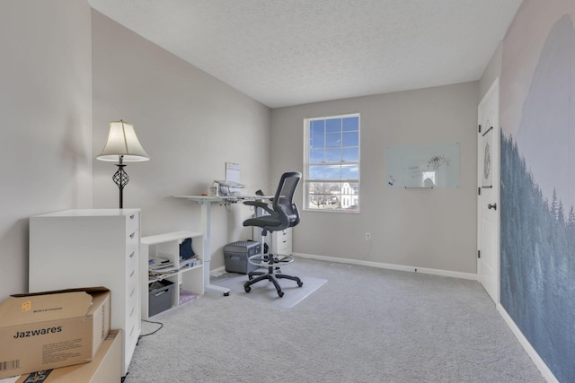 carpeted home office featuring a textured ceiling and baseboards