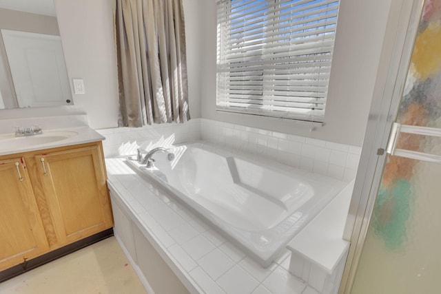 full bathroom featuring vanity and a garden tub