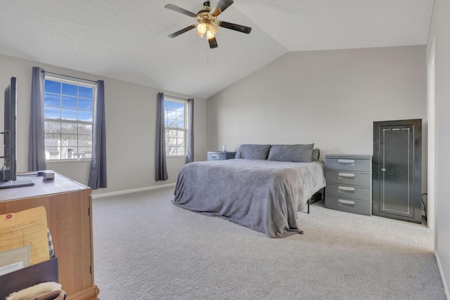 bedroom with carpet flooring, baseboards, lofted ceiling, and a ceiling fan