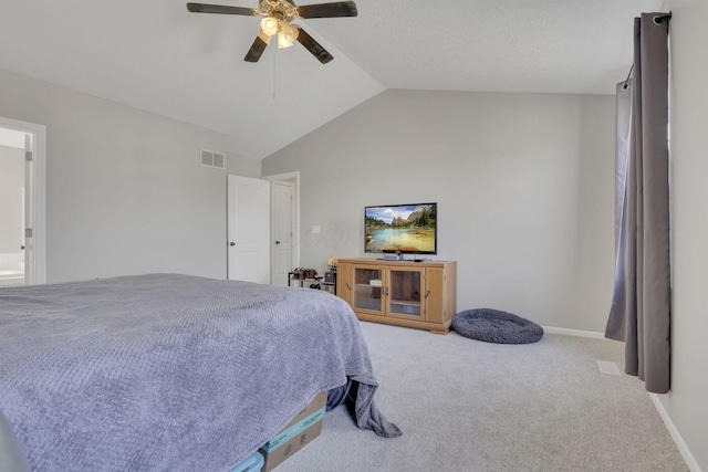 carpeted bedroom with vaulted ceiling, baseboards, visible vents, and ceiling fan