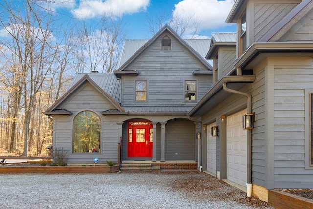 property entrance featuring metal roof and a garage