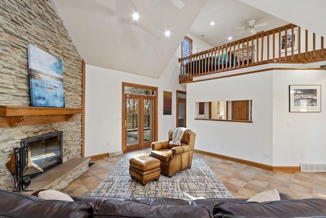 living room with visible vents, baseboards, a high ceiling, and ceiling fan