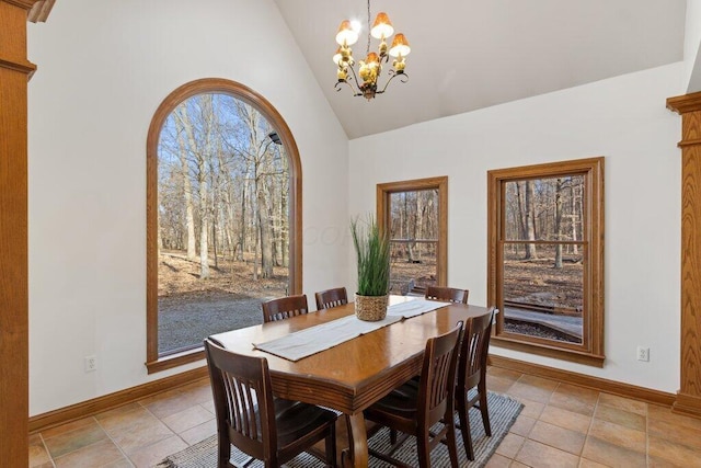 dining space with a chandelier, light tile patterned floors, high vaulted ceiling, and baseboards