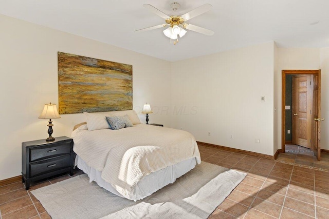 tiled bedroom featuring baseboards and ceiling fan