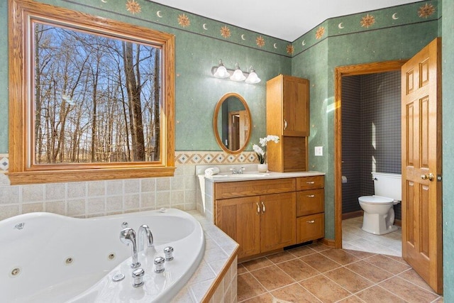 full bath featuring vanity, toilet, a whirlpool tub, and tile patterned flooring