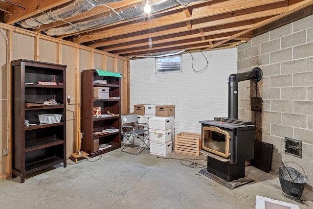 unfinished basement with a wood stove