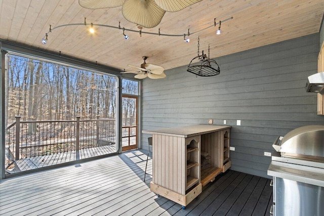 wooden terrace featuring a grill and a ceiling fan