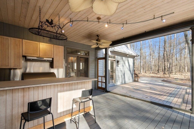 wooden terrace with outdoor dry bar and ceiling fan