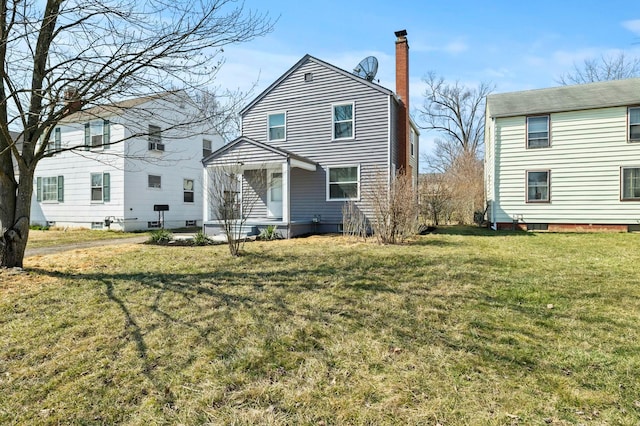 view of front facade with a chimney and a front lawn