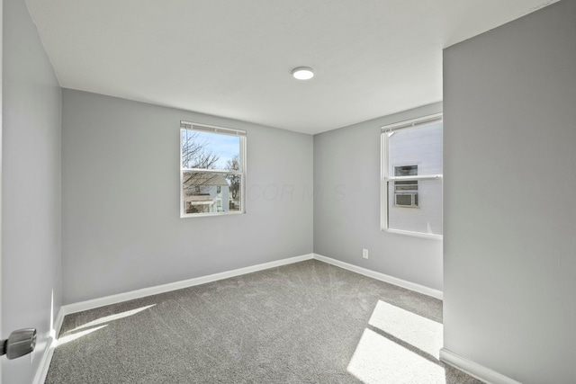 unfurnished room featuring baseboards and carpet floors