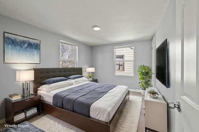 bedroom featuring multiple windows and baseboards