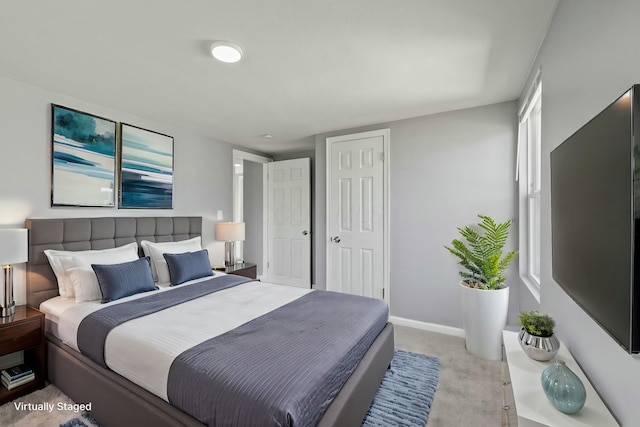 bedroom featuring a closet, baseboards, and carpet floors