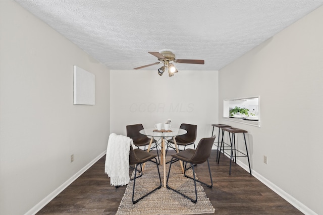 dining space featuring baseboards, ceiling fan, and wood finished floors