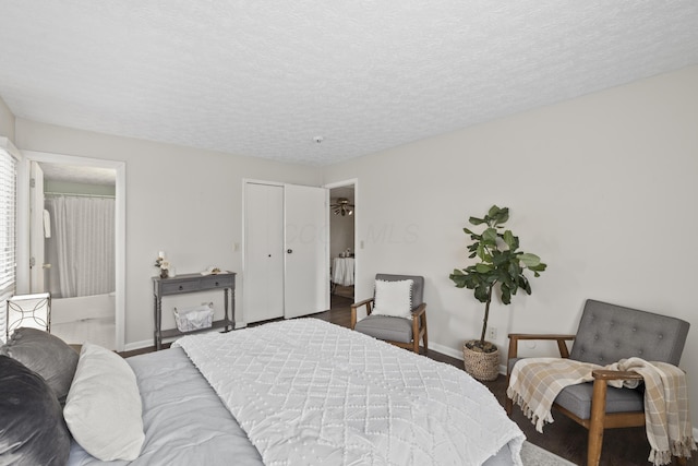 bedroom featuring baseboards and a textured ceiling