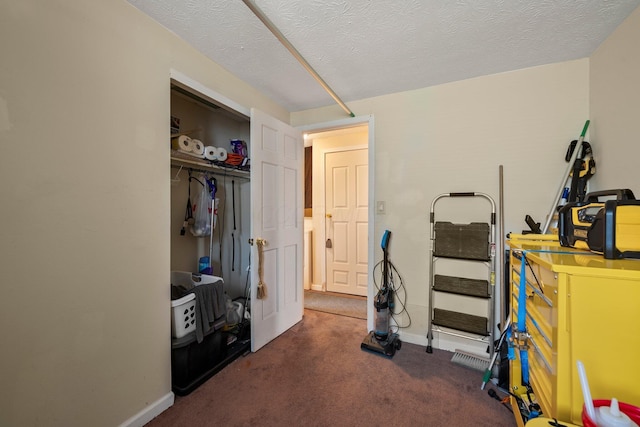 carpeted bedroom with a textured ceiling and baseboards