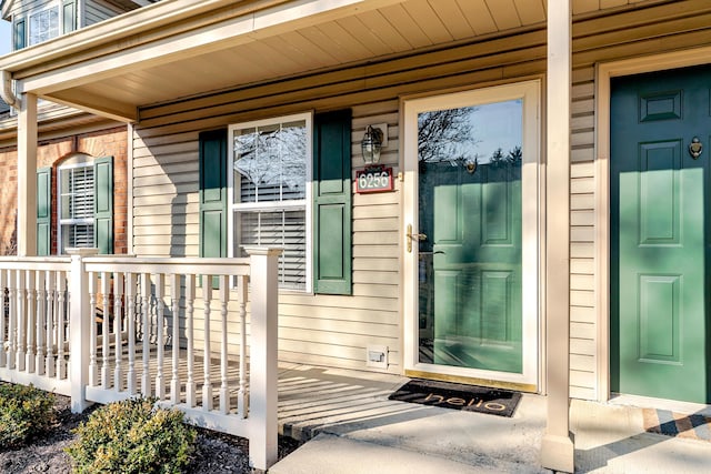 view of exterior entry featuring a porch