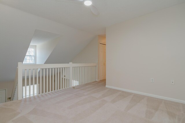 bonus room featuring vaulted ceiling, carpet, baseboards, and ceiling fan