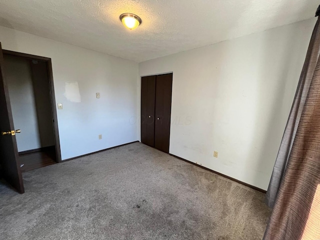 380 W Neff St, Morral, OH 43337 - unfurnished bedroom featuring baseboards, carpet, a closet, and a textured ceiling