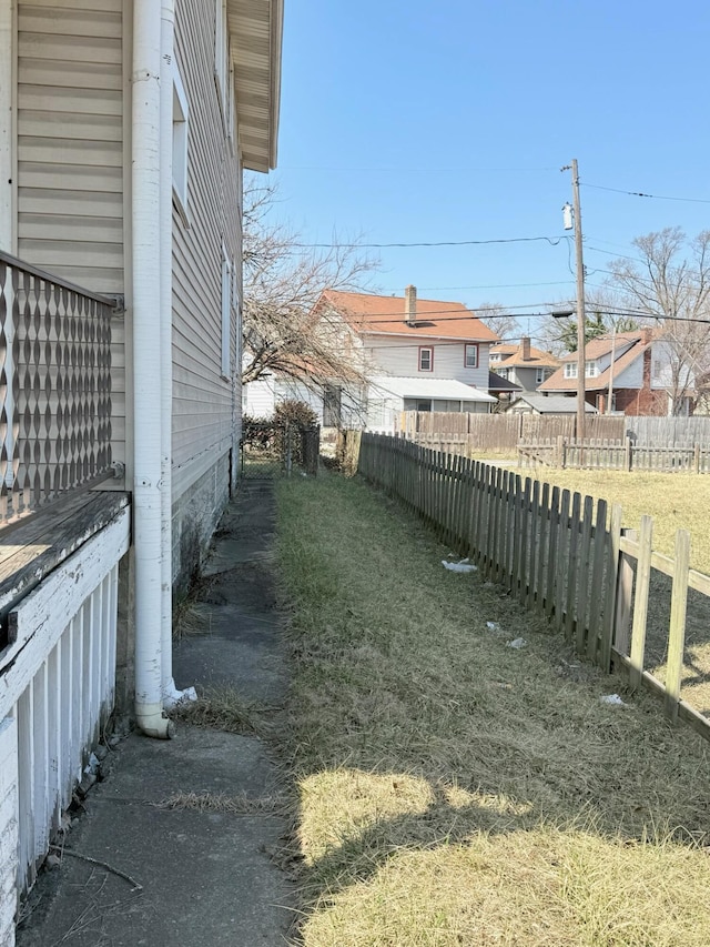 view of yard featuring fence and a residential view