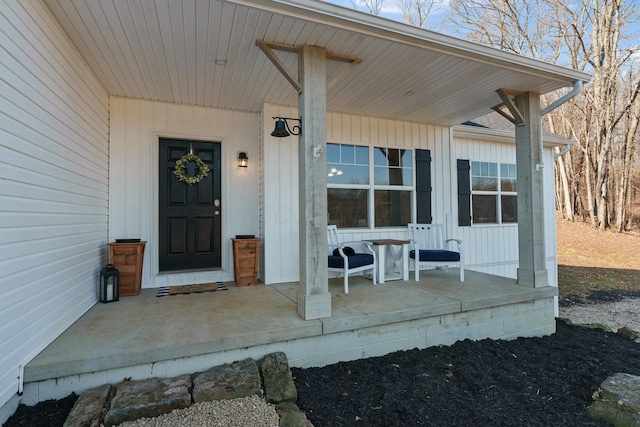 doorway to property featuring board and batten siding and a porch